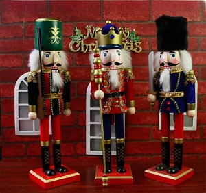 Detailed view of three 38cm wooden Nutcracker soldiers on red bases with festive backdrop