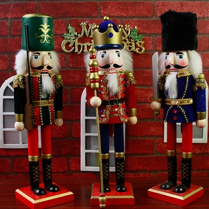 Detailed close-up of three wooden Nutcracker soldiers in green, red and blue festive uniforms