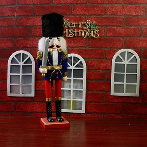 Detail of 38cm wooden nutcracker king in blue velvet uniform with silver sword and red base