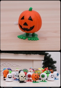 Detail view of clockwork Halloween pumpkin toy with colorful holiday character set