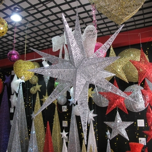 Detail of silver 14-point iron star decoration hanging from ceiling for holiday parties