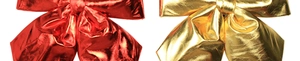 Close-up of red and gold Christmas bows in shiny metallic fabric for festive decoration