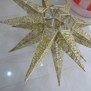 Detailed macro view of a large 3D golden glitter star holiday hanging ornament