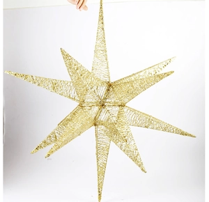 Detailed close-up of golden glittered Christmas explosion star hanging ornament
