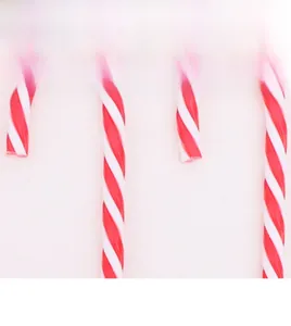 Macro shot of red and white glitter candy cane ornaments with double-processed flash powder