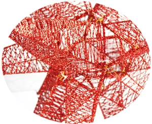 Close-up of red glitter Christmas explosion star with shimmering festive metal texture