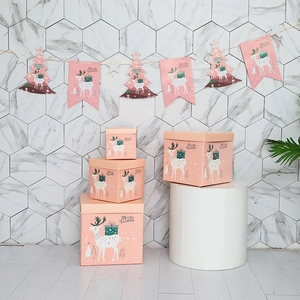 Pink Christmas reindeer gift boxes set with festive bunting flags for window decoration