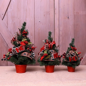Mini Christmas tree set with red berries and HO sign on a rustic wooden background
