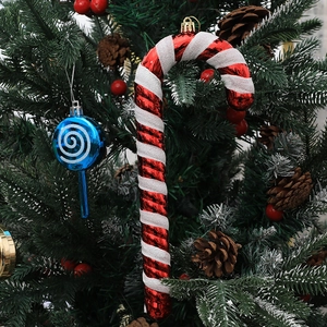 Red white candy cane and blue striped lollipop ornaments hanging on a festive Christmas tree