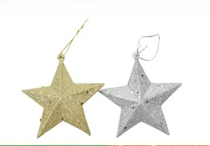 Close-up of sparkling gold and silver glitter star ornaments for Christmas tree decoration