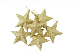 Close-up of six gold glitter star ornaments with hanging strings for Christmas tree decor