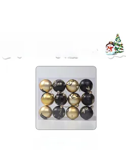 Macro view of 12-piece black and gold Christmas baubles set in transparent box packaging