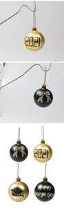 Detail of black and gold graduation ornaments featuring 2021 and mortarboard designs