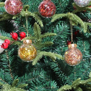 Transparent PET Christmas ornaments with glitter silk filling on green tree branches