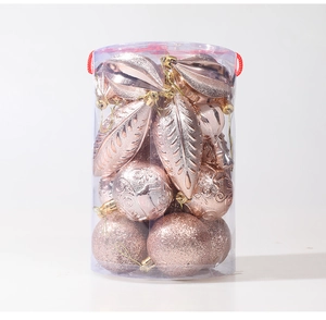 Detailed view of rose gold Christmas ornaments with glitter and embossed textures in a tube