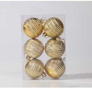 Close-up of golden Christmas balls with wavy texture and glitter in a 6-piece pack
