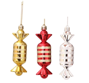 Close-up of three plated candy Christmas ornaments in gold, red and silver with glitter