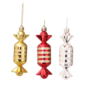 Detailed view of shiny Christmas candy ornaments with glitter stripes and hanging strings