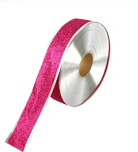 Macro detail of rose pink glitter ribbon roll with silver edges for Christmas crafts