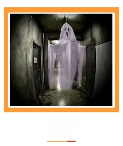 Close-up of hanging white ghost decoration made of sheer fabric for Halloween parties