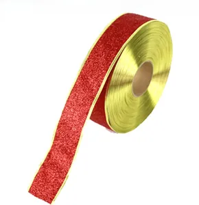 Macro detail of 5cm gold glitter festive ribbon for Christmas gift bows and decor