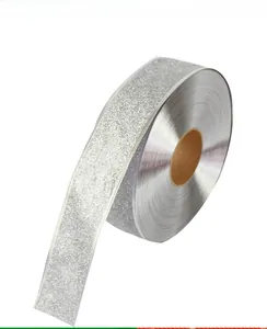 Close-up of sparkling silver glitter ribbon roll for Christmas gift wrapping decor