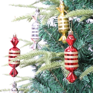 Red and gold candy-shaped Christmas tree ornaments with glitter stripes and hanging strings
