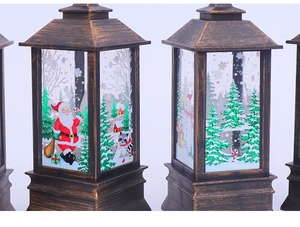 Detail of Christmas lantern showing colorful Santa Claus illustrations and bronze metal finish