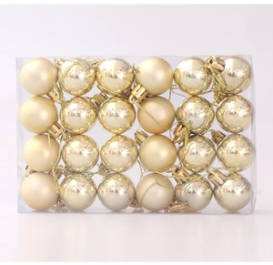 Close-up of 24 pieces of 3cm golden Christmas balls in a transparent PVC box