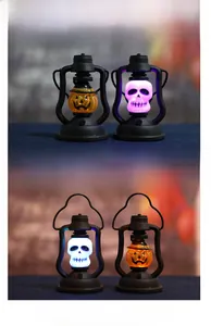 Detail of Halloween LED lanterns with glowing pumpkin and skull patterns in dark setting