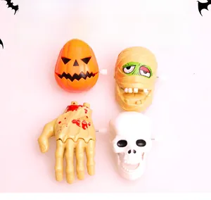 Macro view of 4-piece Halloween wind-up toys set featuring pumpkin and skull characters