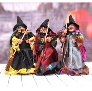 Detailed close-up of a three-piece Halloween witch doll set with brooms and pointed hats