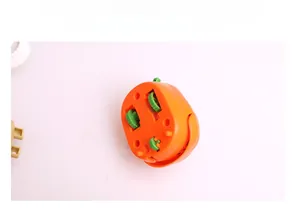 Detail view of the bottom wheels on a clockwork pumpkin toy for Halloween fun