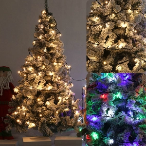 Snow-flocked artificial Christmas tree with warm white and RGB LED string lights