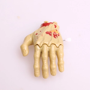 Wind-up crawling zombie hand toy for Halloween parties with realistic fake blood detail