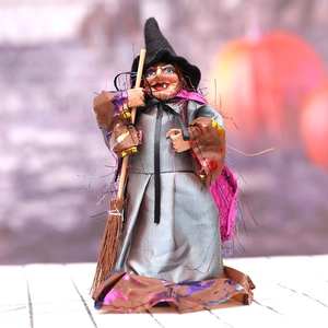 Halloween witch doll decoration with pointed hat and broomstick for spooky party atmosphere