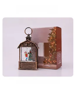 Detail of vintage Christmas barn lantern with Santa scene and festive gift packaging box