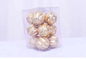 Detail of nine golden spiral glitter Christmas balls in a transparent display box