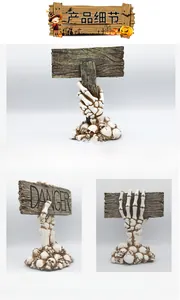 Detailed view of Halloween resin skeleton hand holding a Danger sign over skull base