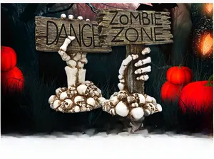 Halloween decor featuring skeleton hands holding Danger and Zombie Zone signs on skull base