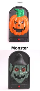 Detail view of pumpkin and ghost Halloween doorbells with red trigger buttons