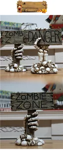 Detail of Halloween skeleton hand signs with Zombie Zone and Danger text for table decor