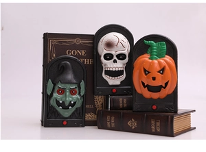 Close-up of Halloween doorbell set featuring witch, skeleton, and pumpkin with red buttons