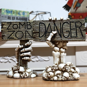 Detail of Halloween zombie zone sign with skeleton hand holding danger warning signs