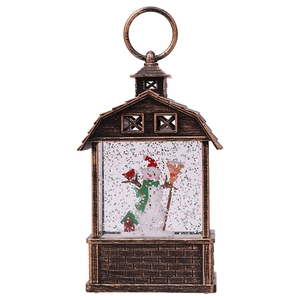 Close-up of vintage bronze Christmas snow globe lantern with snowman and colorful glitter