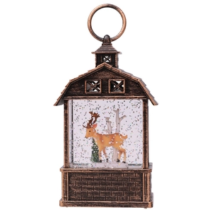 Macro view of vintage bronze barn lantern featuring a reindeer and glitter snow