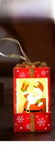 Macro shot of red ABS Christmas gift box lamp featuring Santa Claus and glittery top