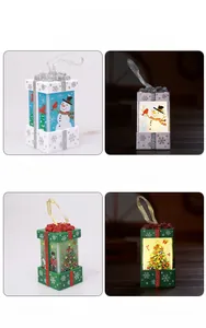 Detail view of snowman and Christmas tree lanterns in both lit and unlit modes