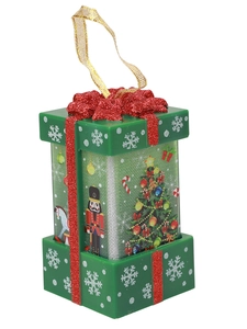 Close-up of green Christmas gift box ornament with red bow and holiday illustrations
