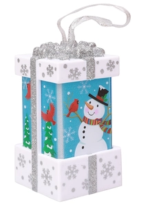 Detail of Christmas lantern ornament featuring a snowman scene and silver glitter bow